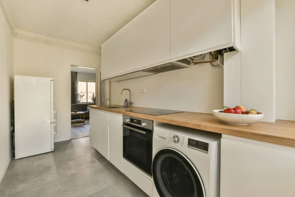 a laundry room with a washer, dryer and dishwasher on the counter in front of the sink