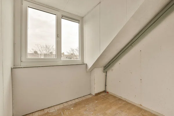 一间有木地板和白墙的空房间 从二楼的楼梯下面望着外面的街道 — 图库照片
