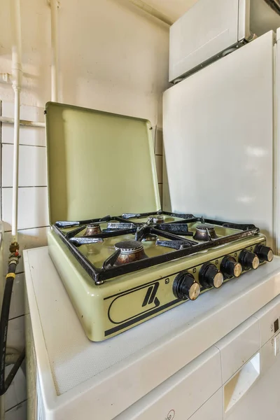 stock image an old stove and refrigerator in a room with no one on the stove top, but its white