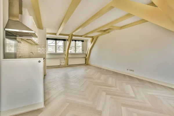 stock image an empty room with wood flooring and white appliances on the wall in this photo is taken from the inside