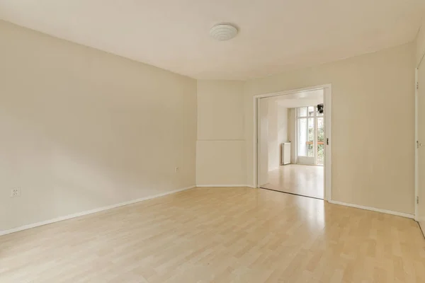 an empty living room with hardwood flooring and white walls in the room is very clean, but there is no light