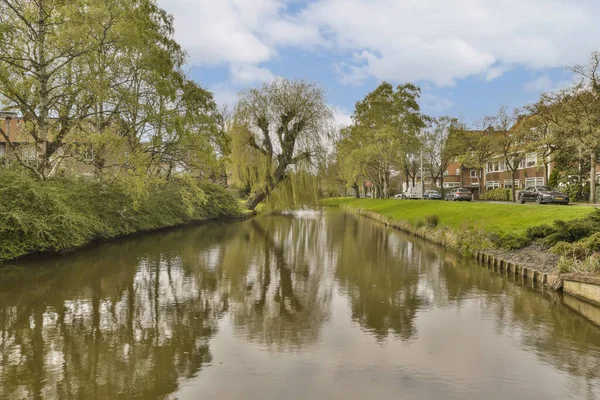 stock image the river with houses and trees on both sides in briney, suffolk, england stock image used under creative commons