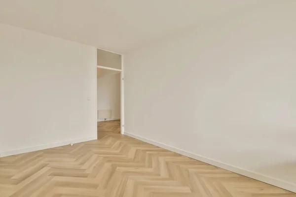 Ein Leerer Raum Mit Weißen Wänden Und Parkettboden Der Mitte — Stockfoto