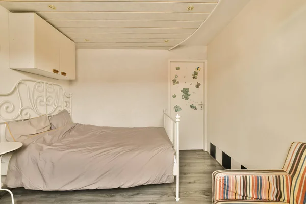 stock image a bedroom with a bed, chair and wallpapers on the walls in this photo is taken from above