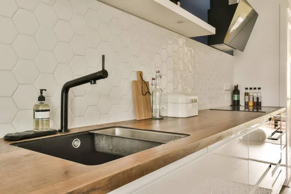 Modern Kitchen White Hexagon Tiles Wall Wooden Countertop Black Tap — Stock Photo, Image