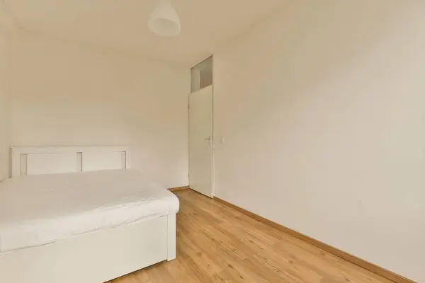 Bedroom White Walls Wood Flooring Room Empty Bed Right Side — 스톡 사진