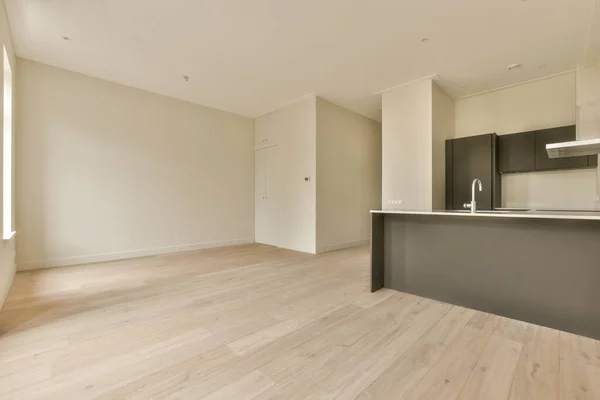 an empty living room with wood flooring and white walls in the room is very clean, but its hard to see
