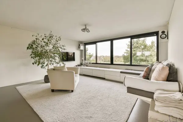 a living room with couches and a large window looking out onto the cityscapearrons com