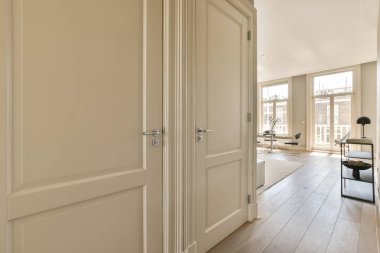 Beyaz duvarları ve ahşap döşemeleri olan boş bir oda.