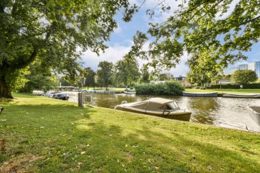 Bereketli yeşil ağaçlar, teknelerin demirlediği sakin bir su geçidi oluşturuyor. Huzurlu bir doğal ortam yaratıyor. Rahatlamak ve düşünmek için mükemmel..