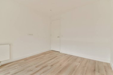 Açık renkli duvarları ve ahşap döşemeleri olan basit ve temiz bir iç mekan. Odanın modern, dağınık bir görünüşü var. Minimalist dekorasyon için ideal..