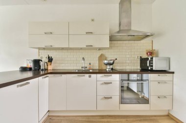 İyi tasarlanmış, modern bir mutfak. Çağdaş dolaplar, aletler ve verimli yemek ve yemek pişirme için organize bir düzen..