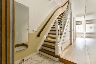 İç mekanın zarafetini arttıran, beyaz balyoz ve yumuşak ışıklandırmalı güzel tasarlanmış bir merdiven. Modern ev dekorasyonu için ideal..