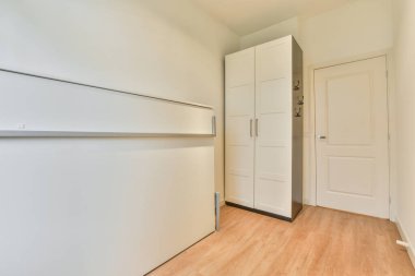 Mobilyasız, geniş bir odanın içinde.