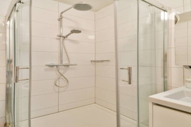 Gösterişli cam kapılar ve minimalist tasarım unsurları olan çağdaş bir duş kabini, şık bir banyo yenilemesi için mükemmel..