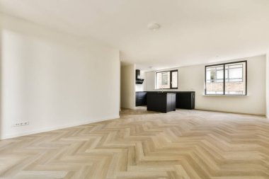 Geniş ve modern bir iç mekan, doğal ışık, parlak mobilyalar ve genel minimalist estetiği geliştiren şık ahşap bir zemin..