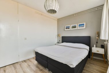 Basit bir yatak odası, minimal dekor ve doğal ışık barındıran modern bir yatak odası. Temiz çizgiler ve dingin renkler rahatlatıcı bir atmosfer yaratır..