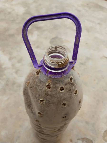 plastic bottle used as  planting pot by making holes in the bottle. Recycling Plastic bottles to create environmental awareness. water bottle used for plant pot