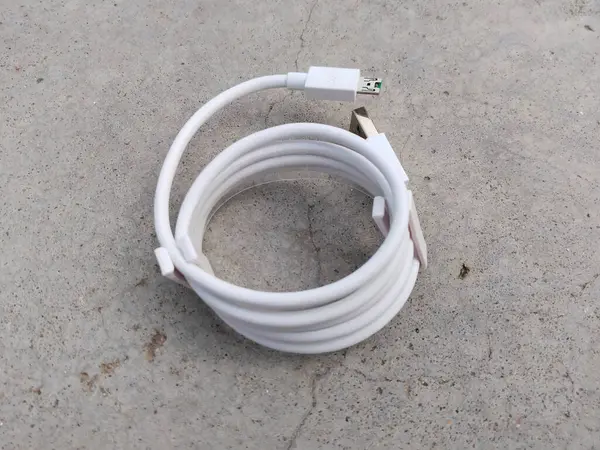 mobile charger cable on the concrete floor