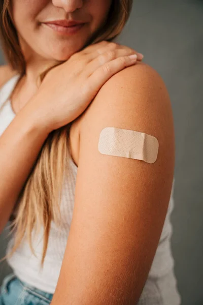Close Female Sitting Band Aid Her Arm Looking Her Injury — Stock Photo, Image