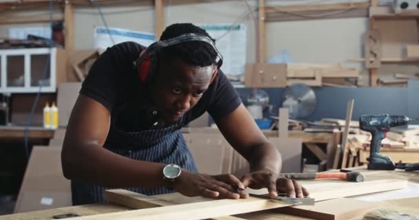 Young Focused African Carpenter His Ear Muff Marking Measuring His — Stockvideo