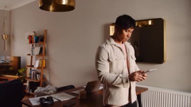 Asian man laughing and smiling while on video call tablet. High quality 4k footage