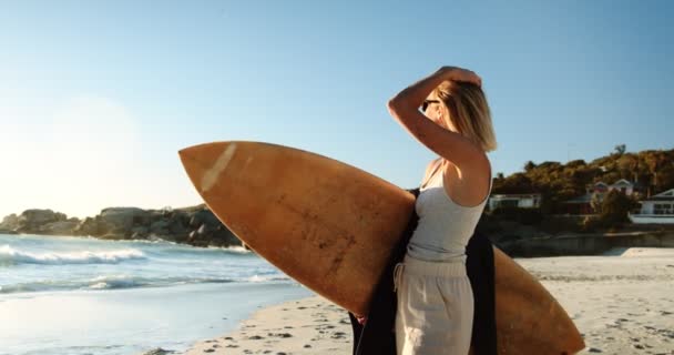 Una Donna Con Una Tavola Surf Che Guarda Oceano Filmati — Video Stock