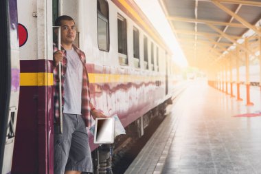 Traveler digital tablet and map in train station. Travel concept.