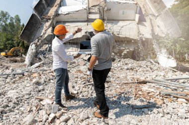 Demolition control supervisor and foreman discussing on demolish building. clipart