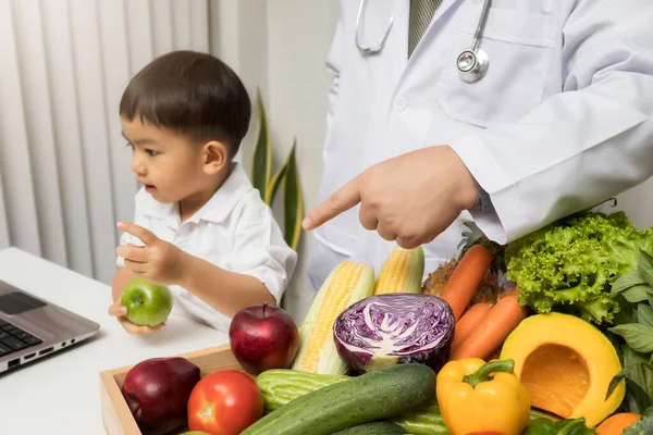 Children and doctors happy to have healthy food.Kid learning about nutrition with doctor to choose eating fresh fruits and vegetables.