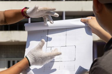 Yıkım denetim denetleyicisi bina yıkım planı ve müteahhiti ile konuşuyor..