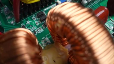Disassembled electrical appliance close-up. Inductors in the inverter. Travel by trolley
