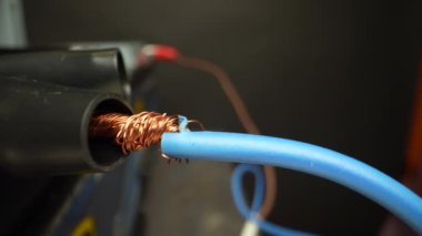 Clamps clips on a car battery. Travel by trolley. Slider movement