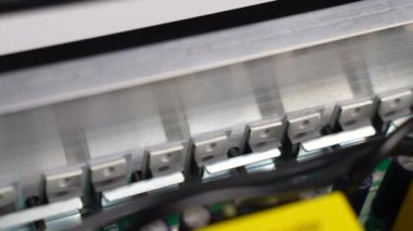 Disassembled electrical appliance close-up. Transistors with a radiator in the inverter