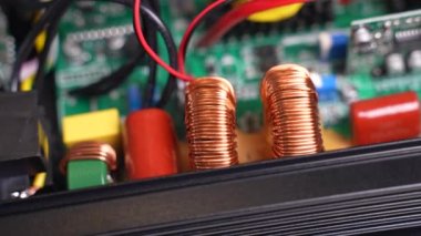 Disassembled electrical appliance close-up. Inductors in the inverter. Travel by trolley