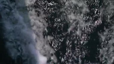 The bow of a white yacht cuts the waves in the sea. Slow motion