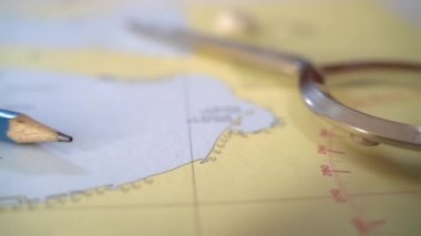 Nautical charts on the table in the captains cabin. Slow motion