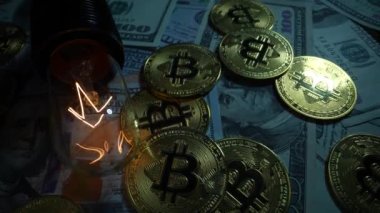 100 dolarlık banknotlar, bitcoin paralar ve parlayan elektrik lambaları. Dolly vurdu.