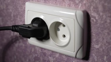 Prizdeki elektrik prizini 220 voltla sökün. Ağır çekim. Dolly vurdu.