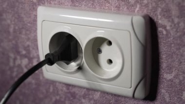 Prizdeki elektrik prizini 220 voltla sökün. Ağır çekim. Dolly vurdu.