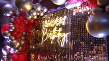 Beautiful neon inscription happy birthday on the photo zone. Slow motion