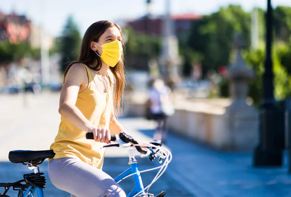 biking cycle in urban street with covid19 mask protection. transport sustainable mobility. virus medical health epidemic.