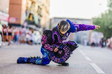 Dancer in a vibrant, sequined costume captivating the crowd with an energetic routine during a hispanic day parade celebration clipart