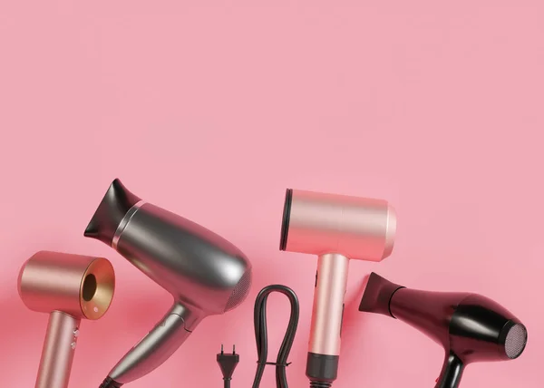 Hair dryers on pink background with copy space. Empty space for your text, advertising. Professional hair style tools. Realistic hairdryer for hairdresser salon or home usage. Tool for drying hair. 3D