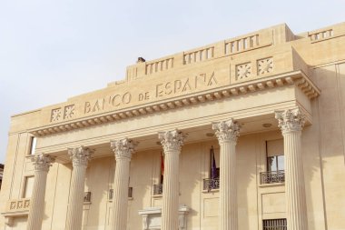 Malaga, İspanya - 26-01-2024: Banco de Espanas cephesinin klasik mimarisi, Corinthian sütunları ve ayrıntılı taş işleri sergileniyor, finansal veya tarihi temalar için mükemmel