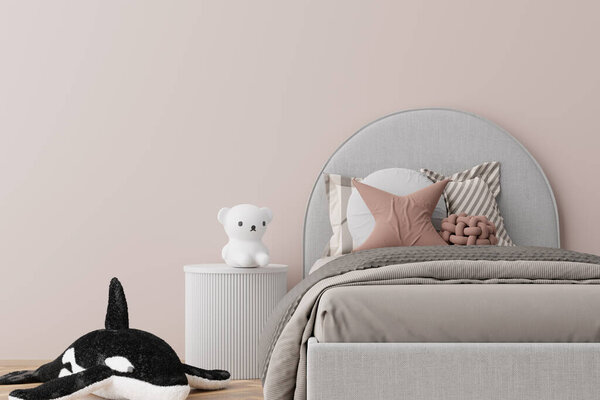 Charming and tranquil kids room featuring soft-hued palette with gray upholstered bed, assorted pillows, plush orca toy, and white bear on modern nightstand. Copy space on the wall. 3D render