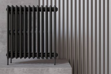 A sleek black radiator stands against a textured wall, providing warmth and elegance to a modern living space. Its minimalist design enhances contemporary home decor while ensuring efficient heating.
