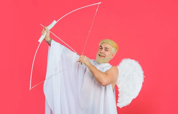 Valentines Day. Male angel with bow and arrows. Cupid in angelic wings shooting arrows of love