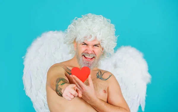 Valentines day cupid. Male angel with red paper heart pointing to you. Cupid in valentine day