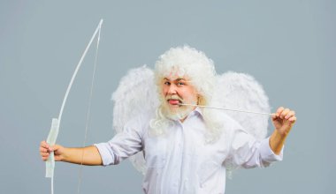 Valentines Day celebration. Cupid angel man in white wings with bow and arrow. God of Love